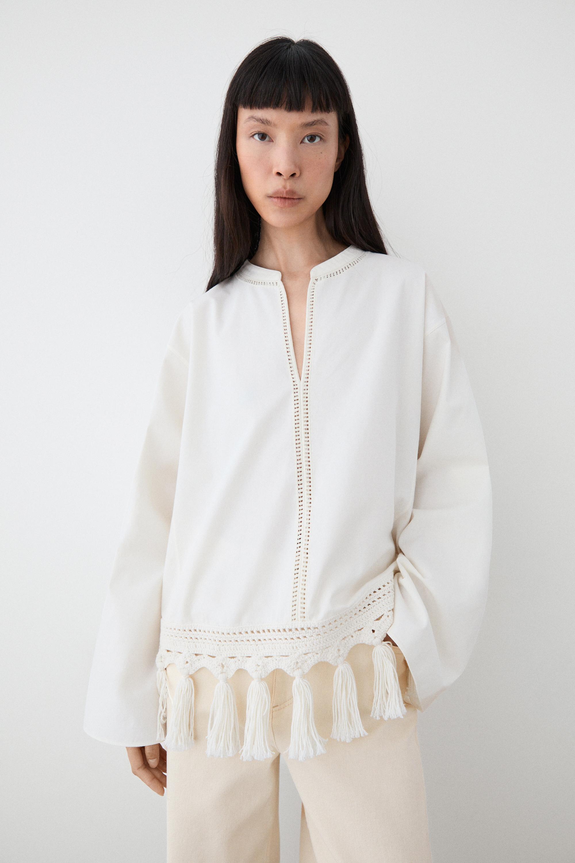 Embroidered blouse with fringed hem